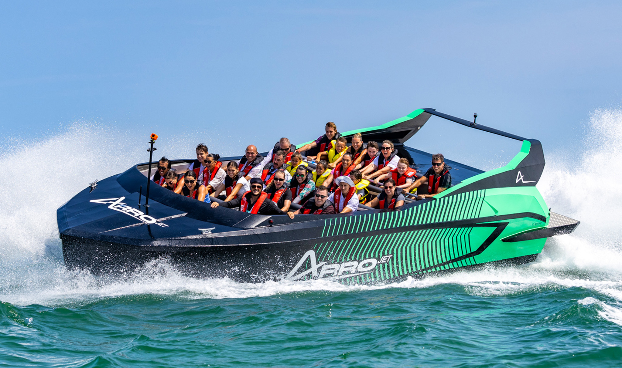 a group of people on a black and mint Jet Boat boat