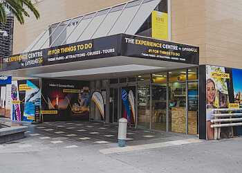 a building with glass doors and black and yellow signs