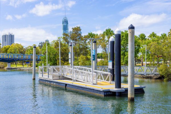 Floating ferry pontoon with green trees in the background